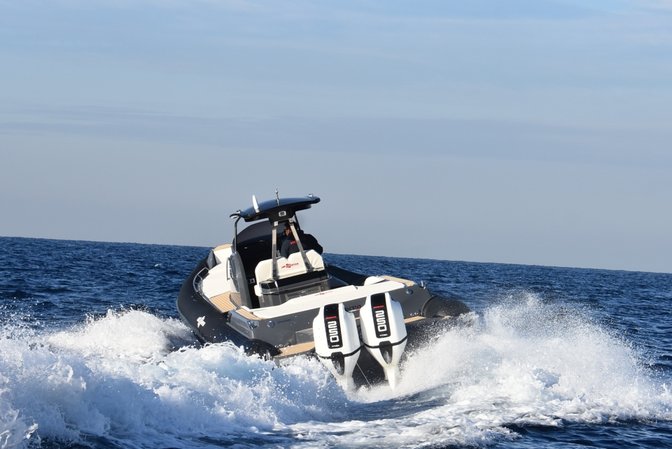 Front three-quarter facing boat with Honda marine engine.