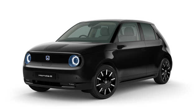 Crystal black pearl Honda e Side facing three quarter.