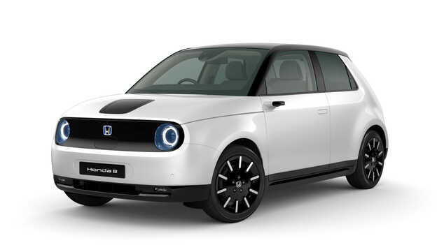 Platinum white pearl Honda e Side Facing three quarters.