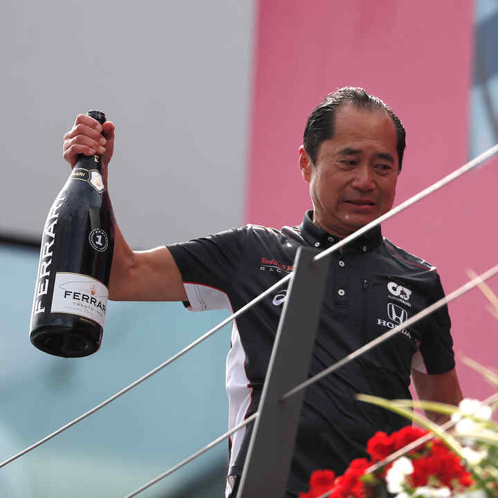 Toyoharu Tanabe con in mano una bottiglia di champagne