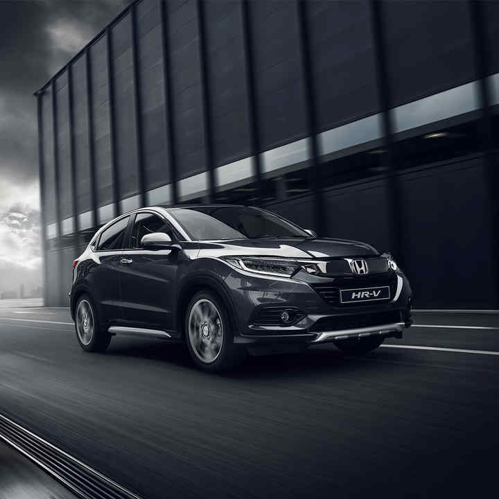 Right three quarters front view of Honda HR-V Legend on exterior scene with buildings.