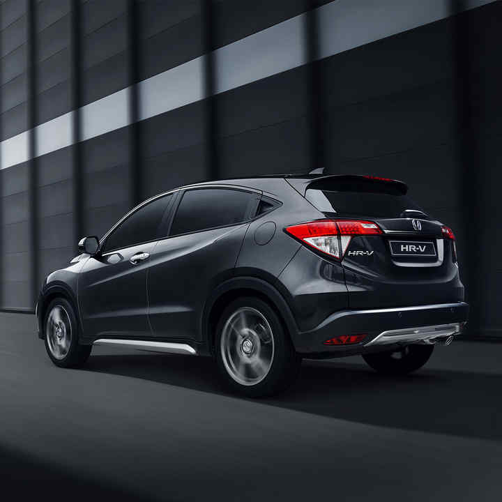 Left three quarters rear view of Honda HR-V Legend on exterior scene with buildings.
