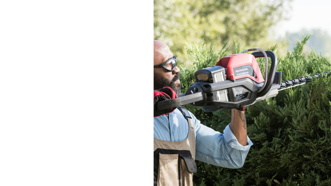 Rear-three quarter view of Honda cordless hedge trimmer with model.