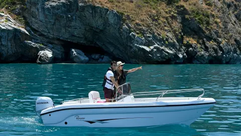 Coppia su una piccola barca sul lago con motore Honda BF.
