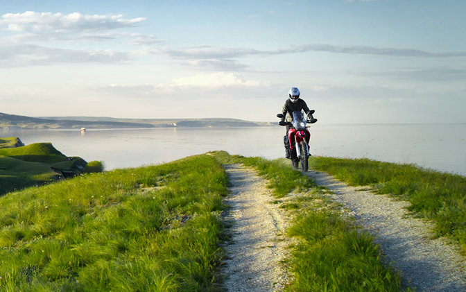 CRF250 Rally con pilota su strada costiera